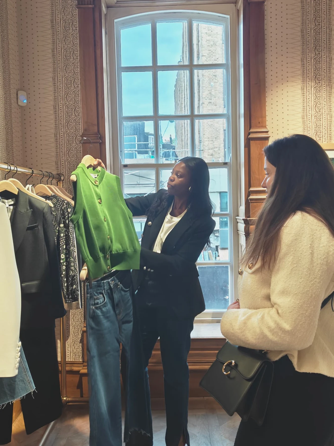 Lionne assisting a client with jeans in a boutique