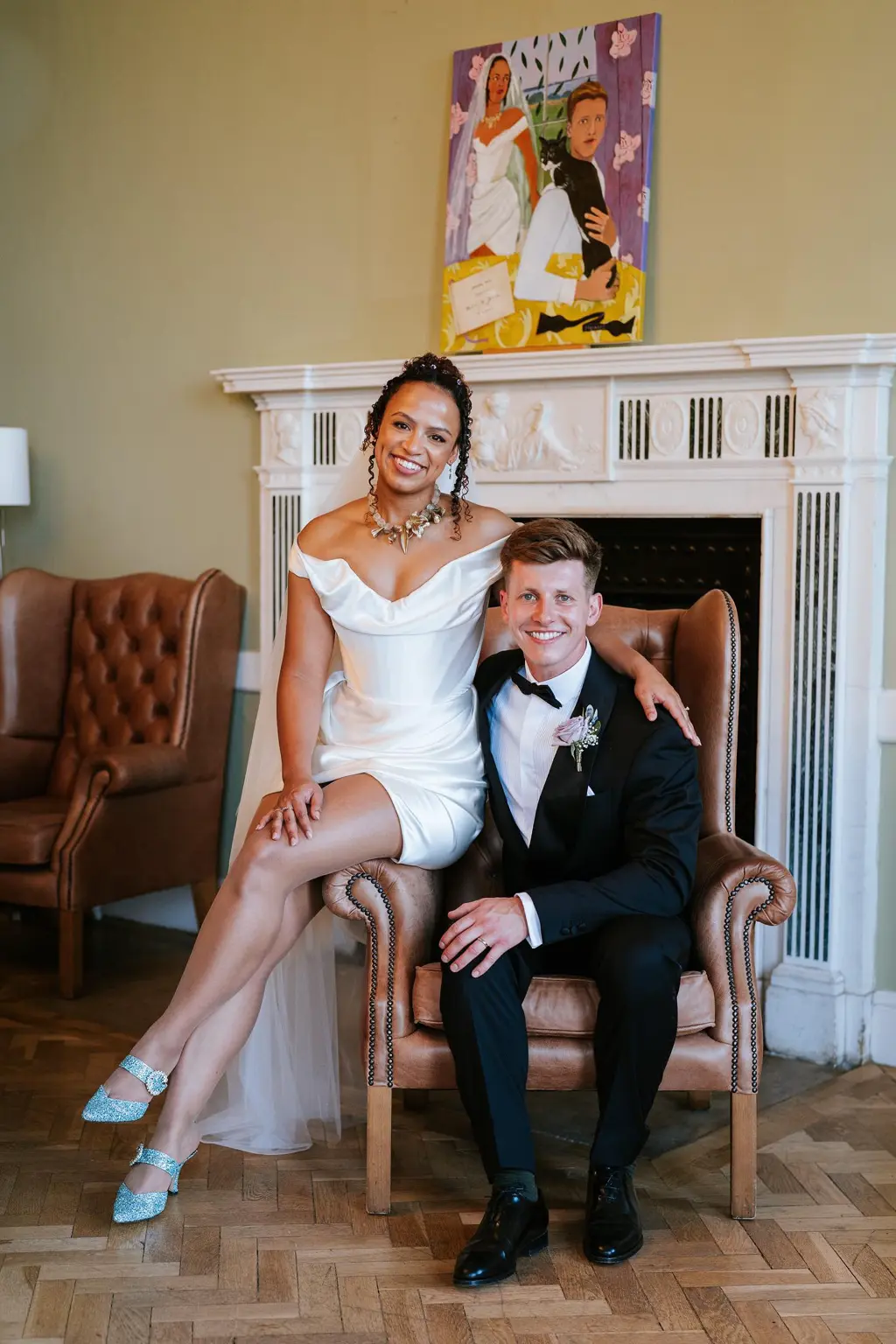 A bride wearing sparkling Jimmy Choo bridal sandals beside her partner